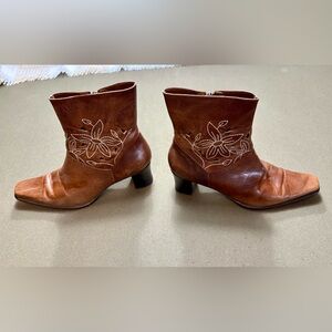 Burnished brown leather boots with flower stitching embellishments